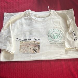 Cream Short Sleeve Tee with Customs Arrivals Print and Cityscape Design